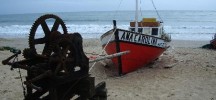 Small fishing boat on the beach of Punta del Diablo